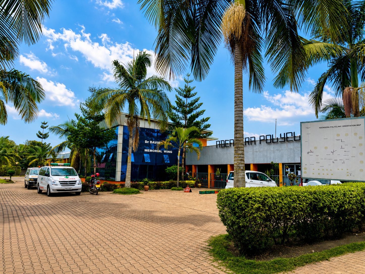 The Ndengera CBC Polyclinic campus in Gisenyi — the Dr David Memorial Wing and clinic ambulances at the main entrance